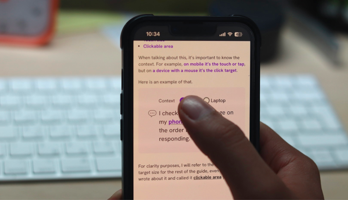 User holding a mobile and try to select from a list of options with their finger covering the content underneath.